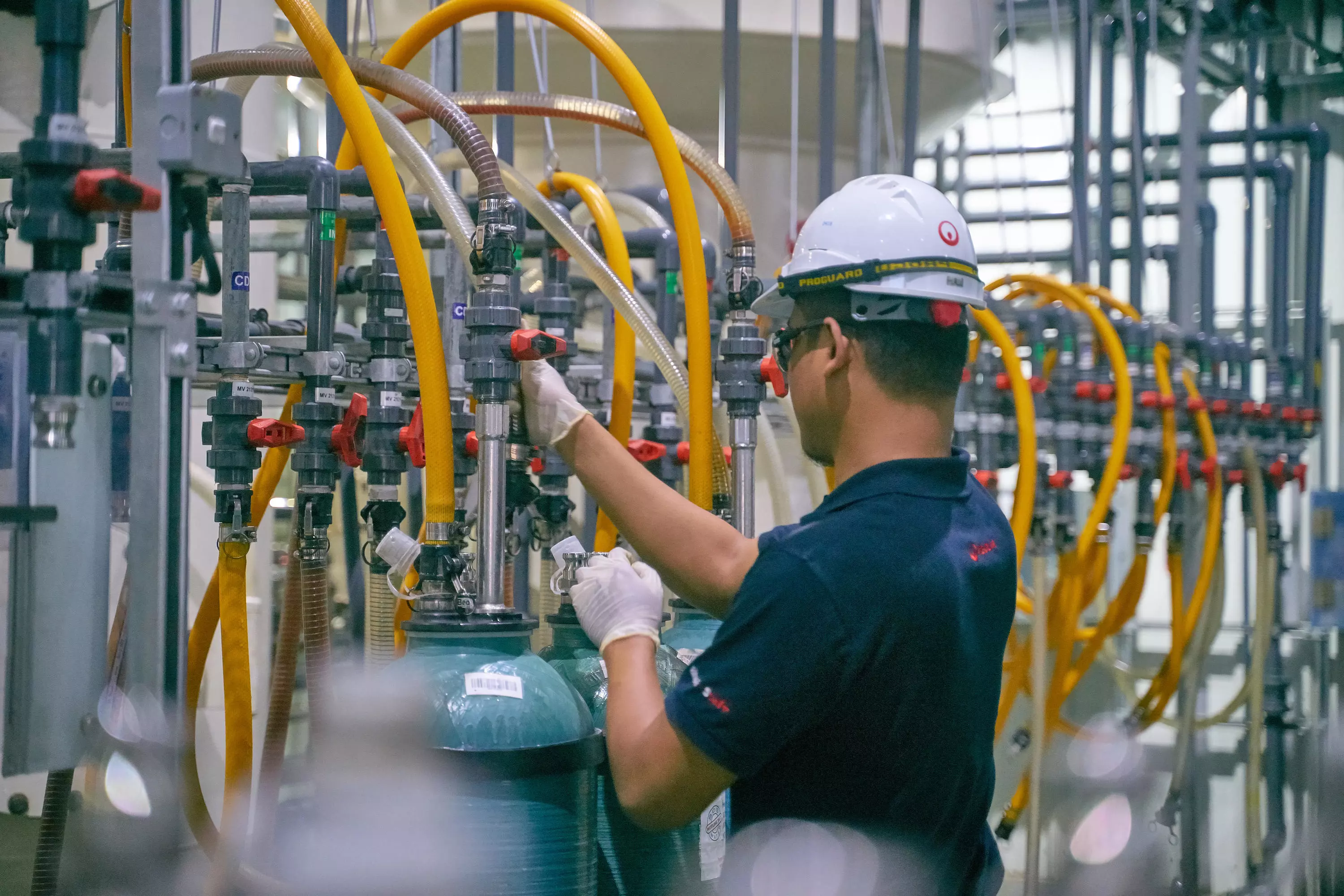 Employee checking water levels for deionization
