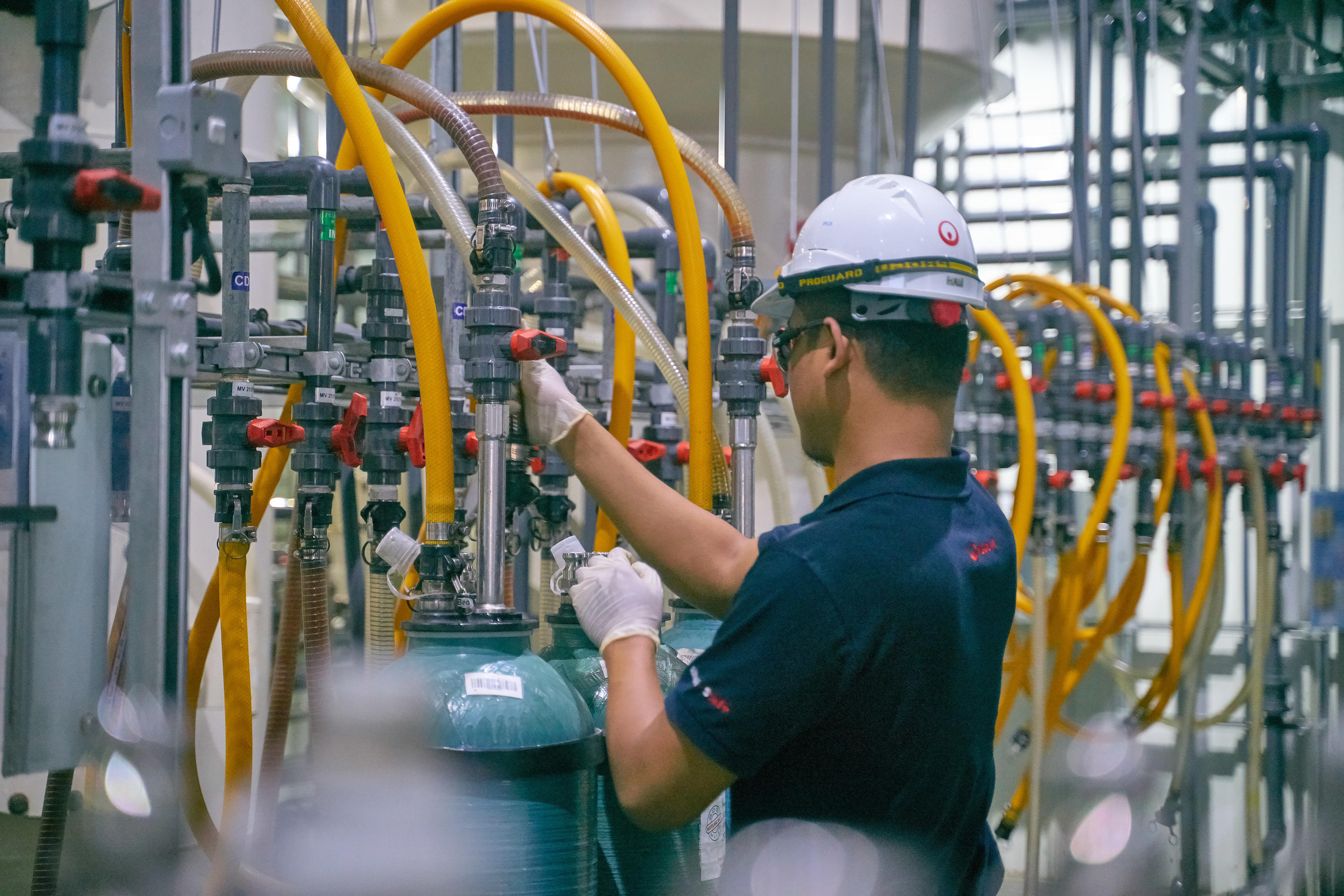 Employee checking water levels for deionization